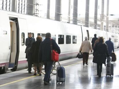 Un grupo de viajeros se dispone a subir a un tren de alta velocidad de Renfe.