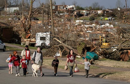 Una familia evacúa su domicilio en Walnut Ridge. Los tornados son resultado de un frente de tormentas en el centro y sur de Estados Unidos.