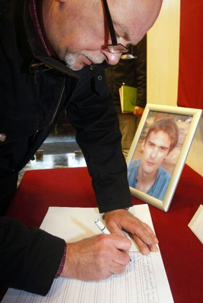 Un hombre firma un libro de condolencias por los franceses asesinados.