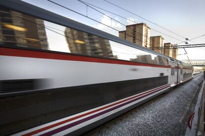 A train rushes by housing in Catalonia.