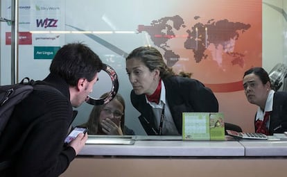 Three Germanwings employees offer information at the airline desk inside Barcelona airport.