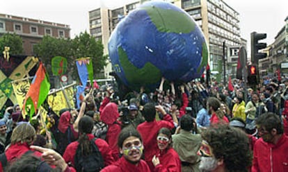 Varios manifestantes juegan con una bola del mundo en el centro de Madrid.