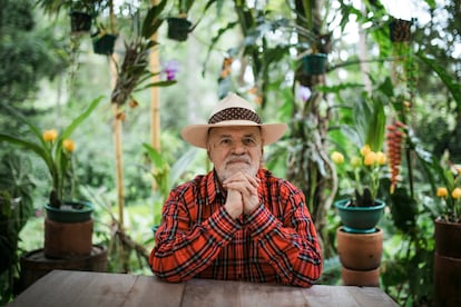 Guillermo Ángulo, rodeado de orquídeas, afuera de su casa en  Choachí, en el departamento de Cundinamarca.