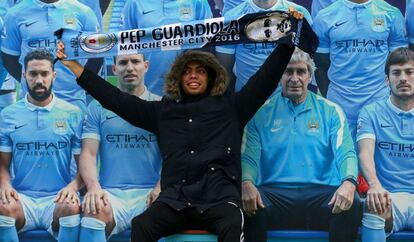 Un fan del City posa con una bufanda de Pep en el Etihad Stadium