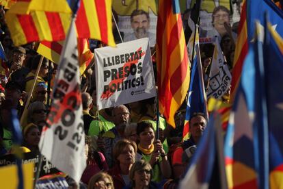 Protesters wave a sign reading: "Freedom for political prisoners."