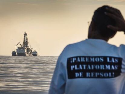 A conservationist observing Repsol's drilling ship last November.