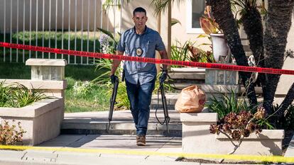 Investigators remove firearms from a house in the 8500 block of E. Canyon Vista Dr. in Anaheim, Calif., on Aug. 4, 2023