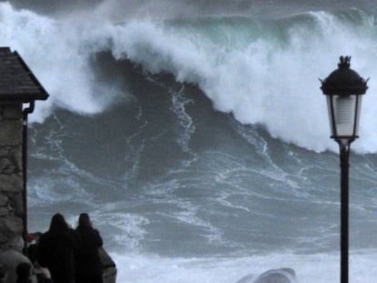 Varios turistas graban las olas este jueves en la costa de Muxía (A Coruña).