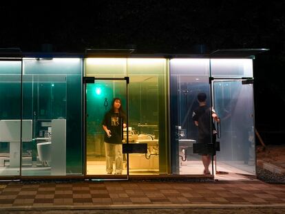 Tokyo (Japan), 20/08/2020.- Visitors use a new public toilet designed by Pritzker Prize-winning architect Shigeru Ban at a park in Tokyo, Japan, 20 August 2020. Ban's designed toilet is surrounded by opacity-changing glass panes that turn opaque when a user enters the toilet booth and locks the door. When the booth is free the glass remains transparent. The toilets are installed at Shibuya to change the old and negative images of public toilet in Japan being dirty, dark and dangerous before the postponed Tokyo 2020 Olympic and Paralympic Games next year. The costs are expected to amount to about 700 million yen to renovate seven locations to be installed at Shibuya in Tokyo in 2020. (Japón, Tokio) EFE/EPA/KIMIMASA MAYAMA