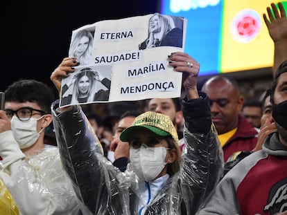 Fã de Marília Mendonça levanta cartaz em sua homenagem no jogo entre Brasil e Colômbia, nesta quinta, em São Paulo.