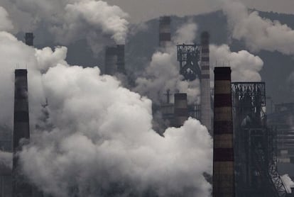 HEBEI, CHINA - NOVEMBER 19: Smoke billows from smokestacks and a coal fired generator at a steel factory on November 19, 2015 in the industrial province of Hebei, China. China's government has set 2030 as a deadline for the country to reach its peak for emissions of carbon dioxide, what scientists and environmentalists cite as the primary cause of climate change. At an upcoming conference in Paris, the governments of 196 countries will meet to set targets on reducing carbon emissions in an attempt to forge a new global agreement on climate change. (Photo by Kevin Frayer/Getty Images)