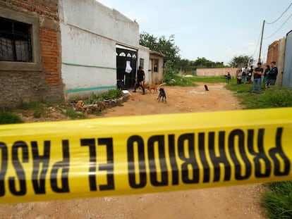 Personas observan el exterior de un centro de rehabilitación donde un grupo armado asesinó a seis personas, en Tlaquepaque, Estado de Jalisco (México), el 25 de julio de 2022.