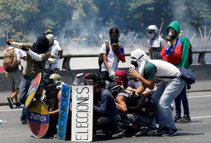 Un grupo de manifestantes opositores choca con la policía durante una protesta contra Nicolás Maduro, este miércoles en Caracas.