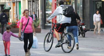 Una mujer y su hija caminan por un bulevar en Montevideo