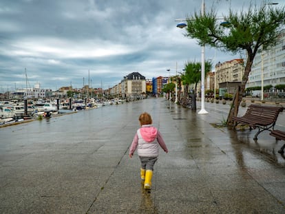 Una niña pasea por Santander este viernes, a pesar de la lluvia esta mañana.