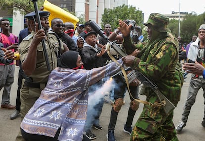 A protester faces the police during a protest for death in police custody of the blogger Albert Ojwang, in Nairobi, on June 12. 
