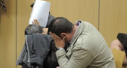 El vigilante León y los guardias civiles Palomo y Cano se tapan la cara al comenzar el juicio.