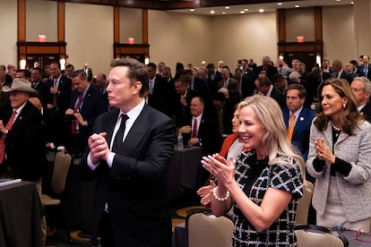 Elon Musk listens as President-elect Donald Trump addresses Republican lawmakers on Nov. 13 on Capitol Hill in Washington.