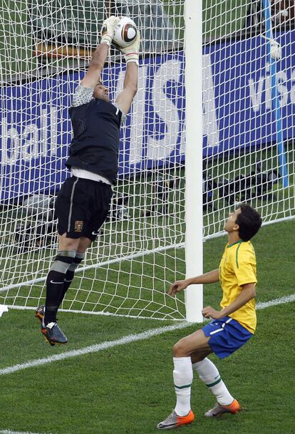 El portero portugués Eduardo atrapa un balón ante la mirada del brasileño Nilmar.