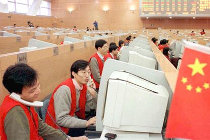 Agentes bursátiles dan órdenes de compraventa en la Bolsa de Shanghai.