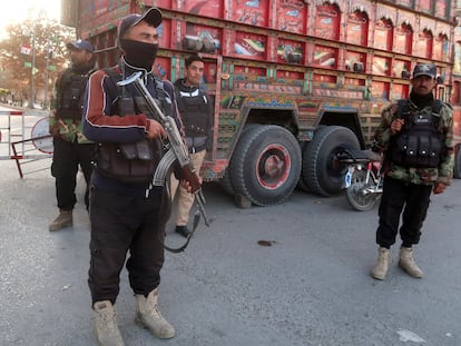 Pakistani security officials stand guard at a checkpoint in Quetta, amid increased security after a deadly suicide bombing targeting Pakistani soldiers in Dera Ismail Khan, Pakistan, 12 December 2023