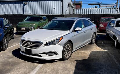 A Hyundai sedan sits in the parking lot of East Bay Tow Inc.