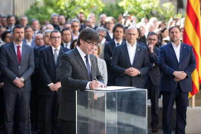 Catalan regional leader Carles Puigdemont signs the manifesto authorizing the independence referendum set for October 1.