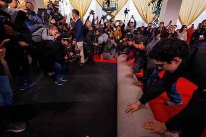 Workers roll out the red carpet along Hollywood Blvd.