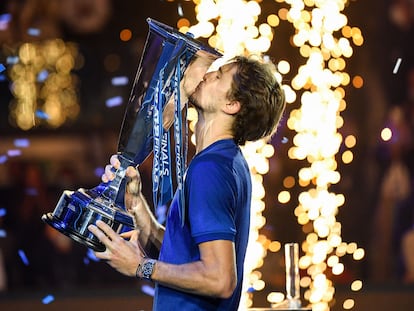 Germany's Alexander Zverev celebrates with the trophy after winning against Russia's Daniil Medvedev during their final match of the ATP Finals at the Pala Alpitour venue in Turin on November 21, 2021. (Photo by Marco BERTORELLO / AFP)