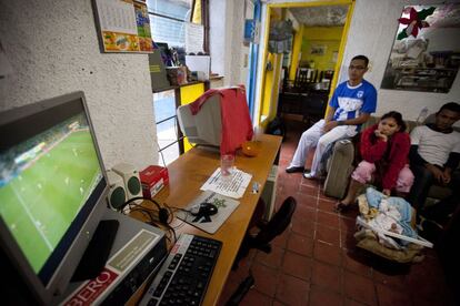 Migrantes centroamericanos observan el encuentro de futbol entre Honduras Ecuador en el albergue Tochan durante el Mundial de Brasil 2014.