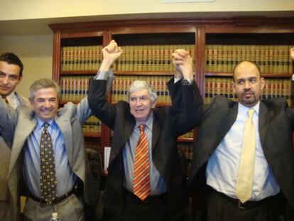 Luis Posada, center, with his lawyers on hearing the ruling.