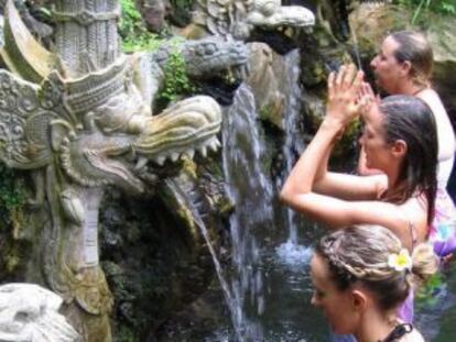 Peregrinos realizan abluciones en una fuente sagrada en Bali