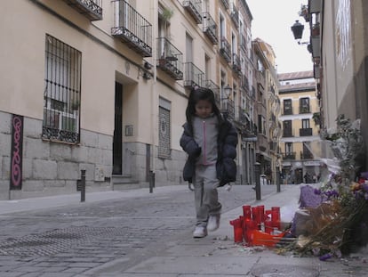 Una niña, camino del colegio, pasa junto al memorial de Mamen Mbaye en Lavapiés. ZAVAN FILMS