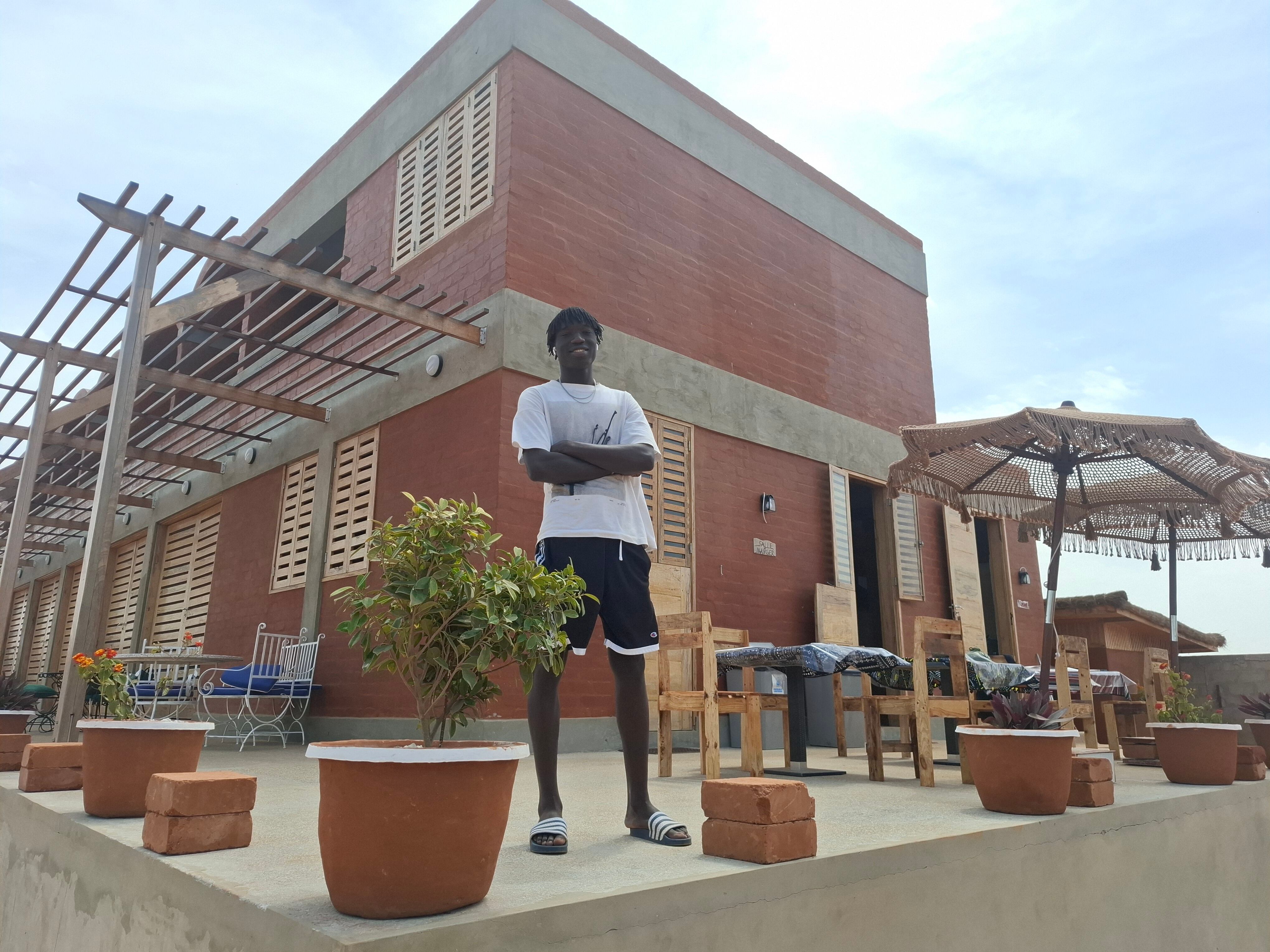 Modou Gueye, joven de Kayar que hoy vive y trabaja en Tenerife, delante del edificio principal del hotel escuela Baobab.