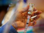 Pat Moore, with the Chester County, Pa., Health Department, fills a syringe with Moderna COVID-19 vaccine before administering it to emergency medical workers and healthcare personnel at the Chester County Government Services Center, Tuesday, Dec. 29, 2020, in West Chester, Pa. (AP Photo/Matt Slocum)