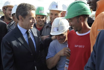 Sarkozy habla con unos obreros durante su visita de hoy a Carcasona.