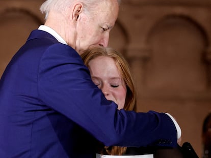 U.S. President Joe Biden embraces Jackie Hegarty, a Sandy Hook school shooting survivor during the 10th Annual National Vigil for All Victims of Gun Violence in Washington, U.S. December 7, 2022.