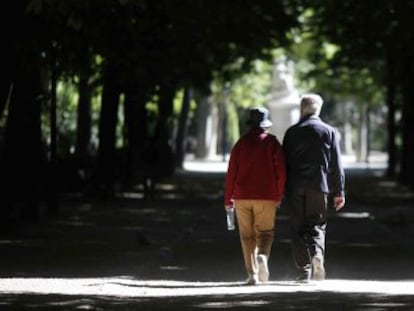 Dos jubilados pasean por el parque del Retiro en Madrid.