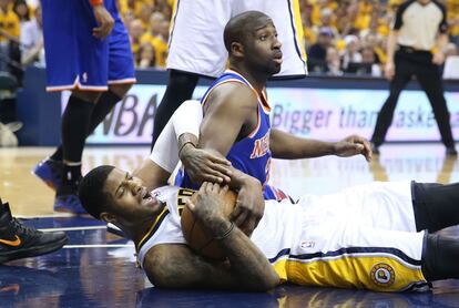 Paul George sostiene el balón tumbado en el suelo ante Raymond Felton