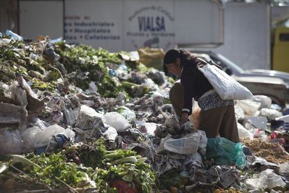 Una mujer busca comida entre los restos en la Central de Abastos de la capital de México.