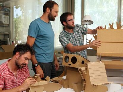 Los tres miembros el estudio Moho Arquitectos con sus diseños de mobiliario de cartón.
