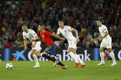 El jugador de la selección española, Iago Aspas, corre con el balón rodeado por jugadores de la selección de Inglaterra durante una jugada del partido