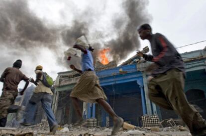 Supervivientes del terremoto corren en una calle de Puerto Príncipe.