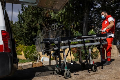 A Lebanese Red Cross doctor loads a stretcher into an ambulance after carrying a dead man to the morgue of the Lebanese People's Aid hospital in Nabatieh, October 17.