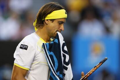 Hung out to dry: David Ferrer bites on his towel during his semifinal match against Novak Djokovic om Melbourne.