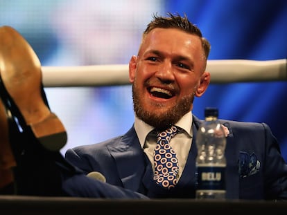 Conor McGregor puts his feet on the table during the press tour for his fight with Floyd Mayweather in 2017.