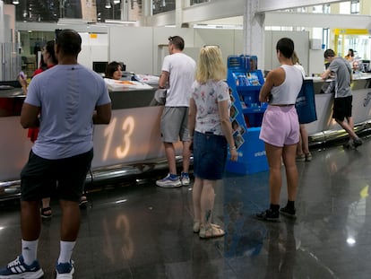 Oficina de Correos en Cibeles, varias personas depositan el voto por correo y recogen la documentación para ejercer el voto.