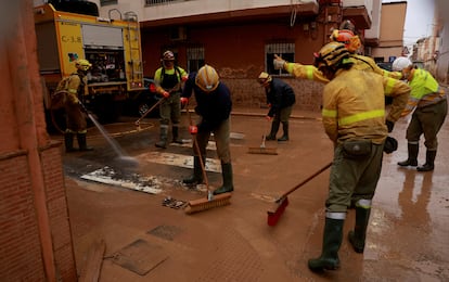 Firefighters cleaned a drainage system blocked by mud on Wednesday in Paiporta, Valencia, as Spain braced for more torrential rain.