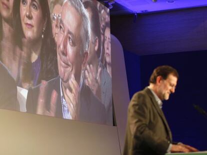 Rajoy, ayer, en Lucena. En la pantalla, Arenas.