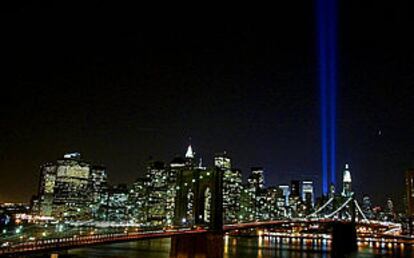 Vista panorámica nocturna de Nueva York: dos haces de luz se elevan sobre Manhattan desde el lugar que ocuparon las Torres Gemelas.